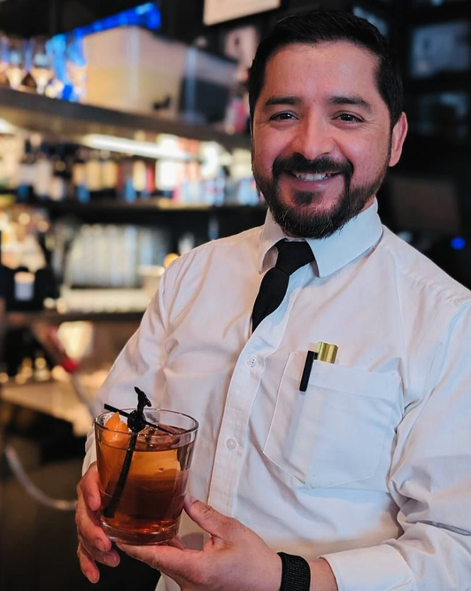 Restaurant server presenting an old fashioned